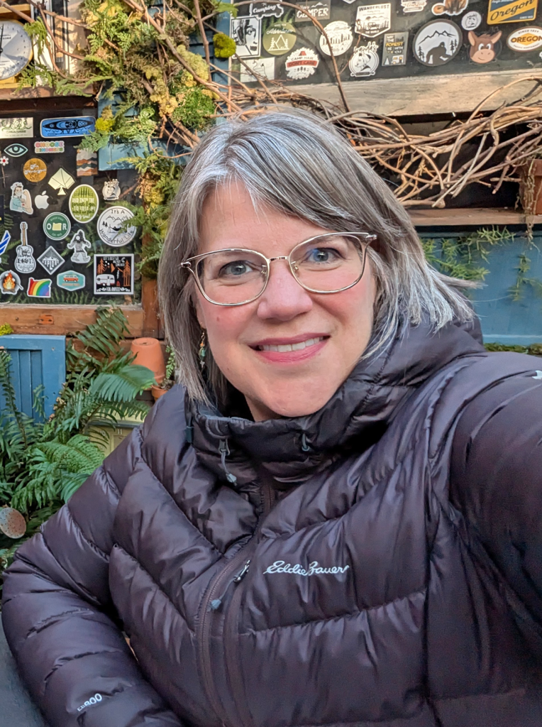 A woman sits at a table.