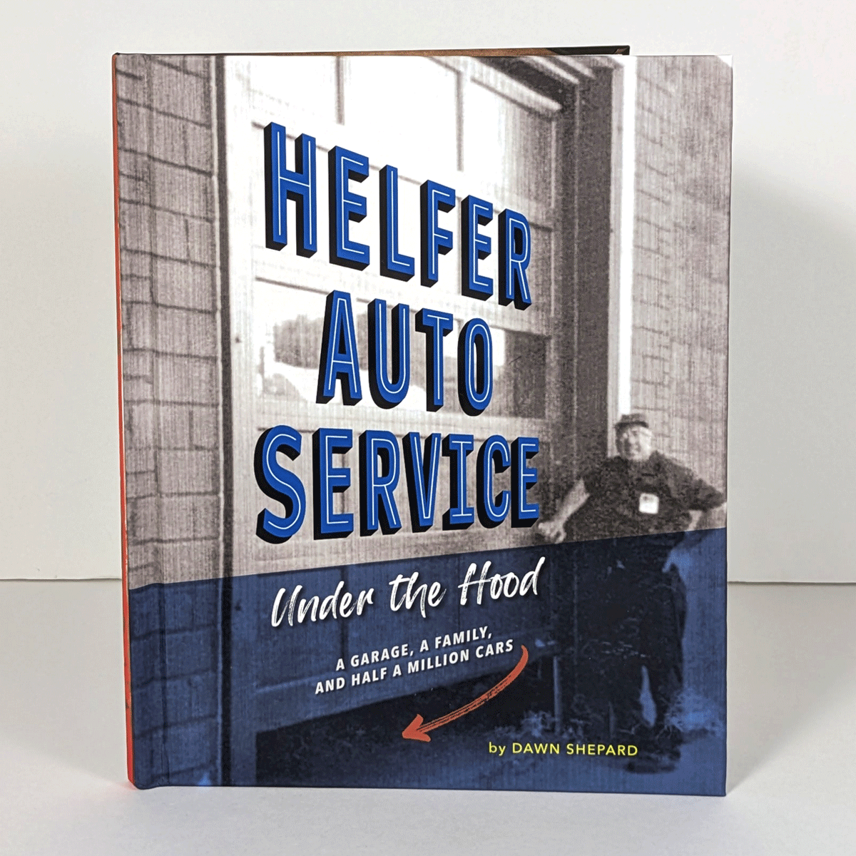 A book cover with a photo of a man standing next to a large garage door.