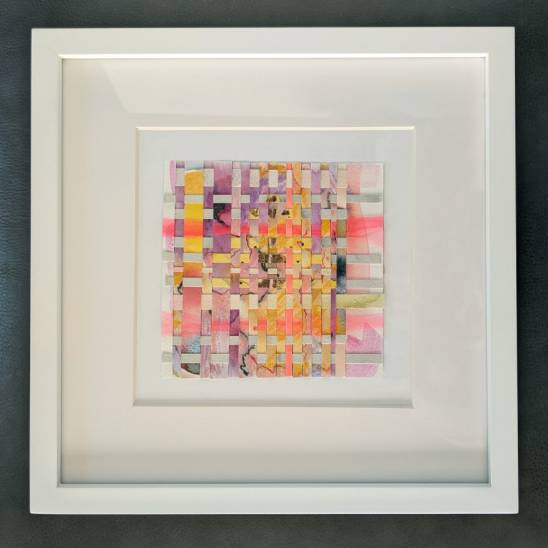 Bright colored pink, purple, and yellow strips of paper woven together.