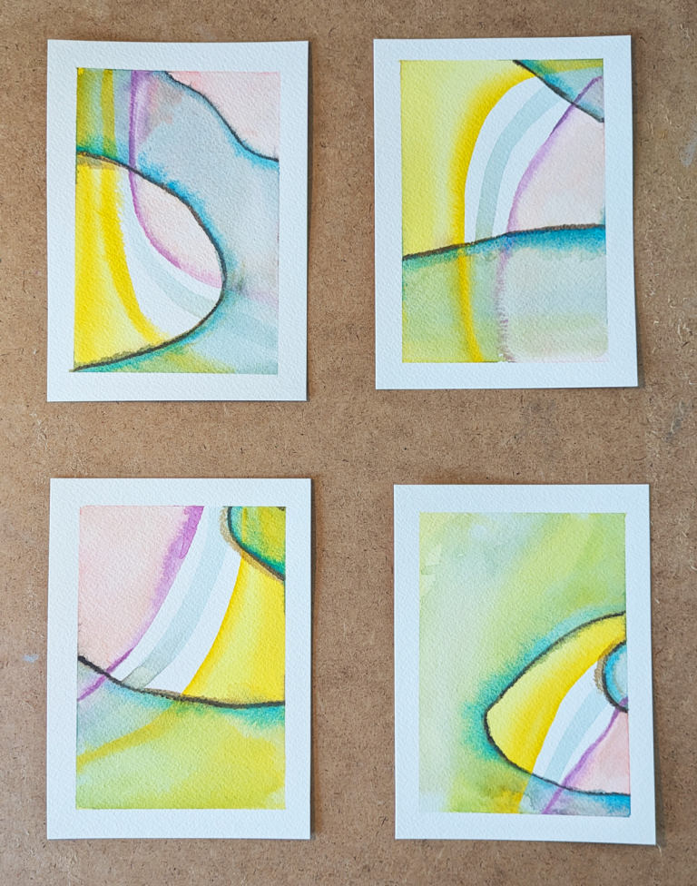 four paintings on a piece of board
